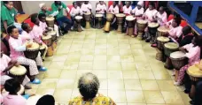  ?? Picture: RAINBOW DREAMS TRUST ?? CIRCLE OF HOPE: Children join in a drumming session at Camp Hope.