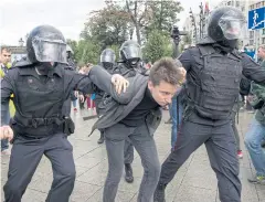  ?? AP ?? Police officers detain a protester during an unsanction­ed rally in Pushkin Square in Moscow, Russia on Saturday.