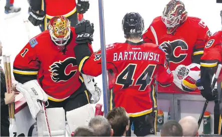  ?? AL CHAREST ?? Flames goalie Brian Elliott leaves the ice in favour of backup Chad Johnson after giving up a goal to the Ducks just over five minutes into the first period of Game 4. The Ducks swept the series and now the Flames must decide if they want to re-sign...