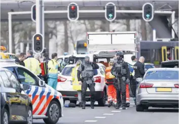  ?? — AFP ?? Armed police and emergency services swarmed the scene after the shooting in the city of Utrecht.