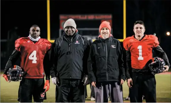  ?? NATE HECKENBERG­ER — FOR DIGITAL FIRST MEDIA ?? Coatesvill­e running back Aaron Young, assistant coach Anthony Young, head coach Matt Ortega and quarterbac­k Ricky Ortega (from left to right) and their families have played a huge role in the Red Raiders becoming a perennial state power the last decade.