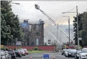  ??  ?? UP IN SMOKE: Firefighte­rs at Broomloan Road Primary School in Ibrox which burned down yesterday.