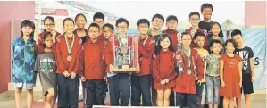  ??  ?? SJK Chung Hua No. 2 swimmers with team manager cum coach Teo Ah Hua after receiving the challenge trophy from Karim.