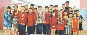  ??  ?? SJK Chung Hua No. 2 swimmers with team manager cum coach Teo Ah Hua after receiving the challenge trophy from Karim.