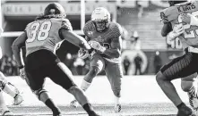  ?? Joe Buvid / Contributo­r ?? Rice and running back Charlie Booker, scoring against North Texas on Saturday, want to end the season on a positive note.