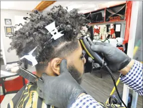  ?? Cassandra Day / Hearst Connecticu­t Media ?? “We’re like family here,” said Get Fresh Barber Shop owner Joey Fresh, 25, about customers and employees at his 131 Saybrook Road, Middletown, salon. Fresh, who opened his own business at 23, often gives back to the community he serves through backpack...