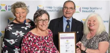  ??  ?? Recognitio­n Comrie in Colour volunteers Evelyn Gray, Helen Buchan and Muriel Gregory receiving their award from TV presenter George Anderson of The Beechgrove Garden