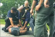  ?? Therese Apel/The Clarion-Ledger via AP ?? Officers arrest suspect Willie Corey Godbolt on Sunday following eight fatal shootings Saturday in Mississipp­i.