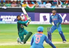  ?? Virendra Saklani/Gulf News ?? Pakistan batsman Shoaib Malek plays a lofted shot during the Asia Cup match against India in Dubai yesterday.