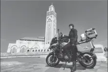  ?? PROVIDED TO CHINA DAILY ?? Li Shaoying visits the Hassan II Mosque in Casablanca, Morocco, on her motorbike in early March.