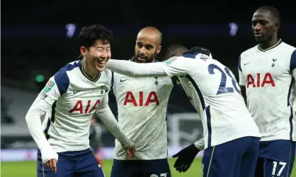  ??  ?? Son Heung-Min takes the acclaim of his teammates after sealing Tottenham’s path into the Carabao Cup final with a typically emphatic finish against Brentford. Photograph: Tottenham Hotspur FC/Getty Images