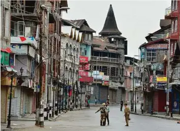  ??  ?? Paramilita­ry troopers stand guard during a curfew in Srinagar yesterday. Around 36 people have been killed and 3,100 wounded, most of them by police fire, in the worst outbreak of violence in six years in the northern state.