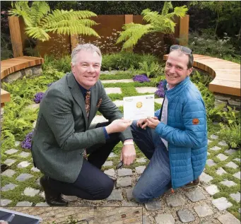  ??  ?? Ashford’s John Durston (right) receives his gold medal for his ‘Nature’s Resurgence’ showgarden.