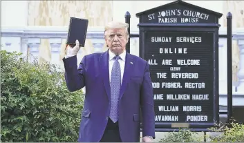  ?? Brendan Smialowski/ AFP / TNS ?? President Donald Trump holds up a Bible outside of St John’s Episcopal Church across from Lafayette Park in Washington on Monday.