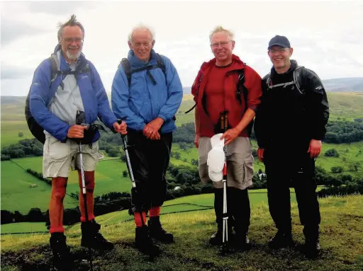  ??  ?? ●● The walkers pause on the summit of Shutlingsl­oe