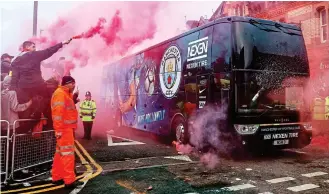  ??  ?? Flare scare: Liverpool supporters pelt City’s bus with missiles and fireworks