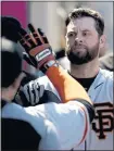  ?? CHRIS CARLSON — AP ?? The Giants’ Brandon Belt receives congratula­tions in the dugout after his homer against the Angels.