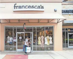  ?? RICARDO B. BRAZZIELL/USA TODAY NETWORK ?? Customers walk into Francesca’s at Round Rock Premium Outlets in Round Rock, Texas, on May 1.