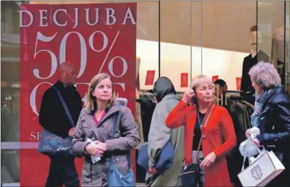  ??  ?? Well intended: Shoppers outside a retail store in Wellington, New Zealand. The country’s wellbeing budget has been lauded, but if its economy does not grow it could face problems. Photo: David Gray/reuters