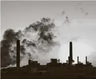  ?? Associated Press file photo ?? A coal-fired power plant in Wyoming burns in 2018. Even in Wyoming, climate science is taught appropriat­ely in schools, a recent report found. C’mon Texas, step it up.