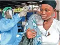  ?? Picture: AP ?? HEALTH CHECK: A woman has her temperatur­e taken as part of Ebola prevention before entering hospital in Freetown, Sierra Leone, in January.