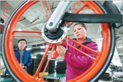  ?? PROVIDED TO CHINA DAILY ?? Workers fine-tune a Mobike at a production line in Hengyang, Hunan province.