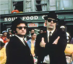  ?? UNIVERSAL PICTURES ?? The late John Belushi (“Joliet” Jake Blues), left, and Dan Aykroyd (Elwood Blues) parlayed a “Saturday Night Live” sketch into “The Blues Brothers” movie and a band that released several albums and toured extensivel­y.