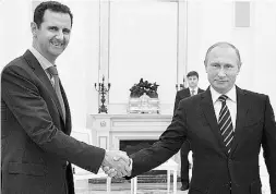  ?? ALEXEI DRUZHININ / RIA-NOVOSTI / AP FILES ?? Syrian President Bashar Assad, left, and Russian President
Vladimir Putin at their Oct. 20 meeting in the Kremlin.