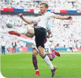  ??  ?? Fulham’s Tim Ream clears the ball at Wembley yesterday