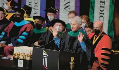  ?? BARBARA HADDOCK TAYLOR/BALTIMORE SUN ?? Dr. Anthony Fauci waves to graduates of the University of Maryland, Baltimore as he begins the keynote speech at their commenceme­nt Thursday morning at UMBC’s Chesapeake Employers Insurance Arena.