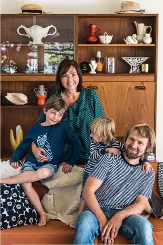  ??  ?? THESE PAGES: The pendant beside the bed dates from 1957 and was found in a flea market in Copenhagen. Niels’ Wandering Albatross work sits above the couple’s bed; the large wooden sideboard was bought from a retro store in Wellington and is filled with...