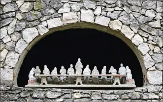  ??  ?? ABOVE: Leonardo DaVinci’s “The Last Supper” is tucked into an archway lined with granite at the Hartman Rock Garden.BELOW: Harry George “Ben” Hartman’s wife Mary said her husband loved coffee. Hartman created a coffee cup and saucer for the Hartman Rock Garden out of concrete, steam gravel and mixed stones.