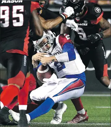  ?? — THE CANADIAN PRESS ?? Alouettes quarterbac­k Johnny Manziel is tackled by the Redblacks after attempting to run in a touchdown during the second half in Ottawa last night.