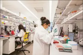  ?? Contribute­d photo ?? Researcher­s at work in lab space at Alexion's research and developmen­t facility at 100 College St. in New Haven.