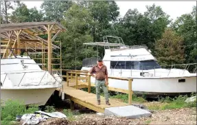  ??  ?? Owner Russell van Elk stands amid his latest addition to Rush Springs — what he calls “the marina.” Van Elk is remodeling out-of-service boats to be unique cabins that can sleep two to eight people. Most days, he can be found somewhere on the property,...