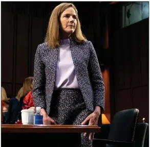  ?? (AP/Stefani Reynolds) ?? Supreme Court nominee Amy Coney Barrett rises during a break in Wednesday’s confirmati­on hearing before the Senate Judiciary Committee. Barrett said several times that “no one is above the law,” but she warned that the Supreme Court has no real recourse to ensure people, including the president, obey its orders.