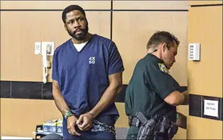  ?? PHOTOS BY LANNIS WATERS / THE PALM BEACH POST ?? Former Greenacres police officer Ervans Saintclair looks at family and friends Friday in a West Palm Beach courtroom before being led away to begin his eight-year prison sentence for not informing his sexual partner that he was HIV-positive.