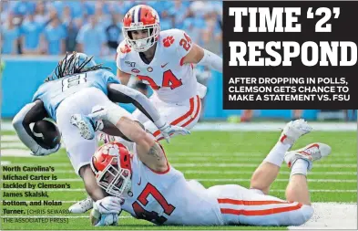  ?? [CHRIS SEWARD/ THE ASSOCIATED PRESS] ?? North Carolina’s Michael Carter is tackled by Clemson’s James Skalski, bottom, and Nolan Turner.