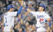  ?? MARK J. TERRILL / AP ?? With 39 home runs, rookie Cody Bellinger (right) helps give the Dodgers a more fearsome lineup than recent L.A. playoff teams that fell shy of the World Series.