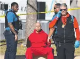  ?? ?? A person is detained near the Kansas City Chiefs’ Super Bowl victory parade. Picture: AFP