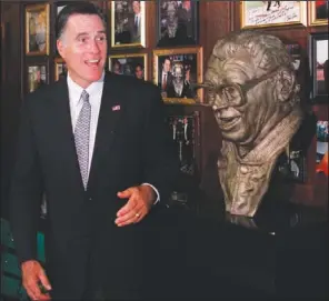  ??  ?? ROMNEY: Republican presidenti­al candidate, former Massachuse­tts Gov. Mitt Romney poses with a bust of famed baseball announcer, Harry Caray, after a private fundraisin­g event at Harry Caray’s Italian Steakhouse restaurant in Chicago Tuesday.