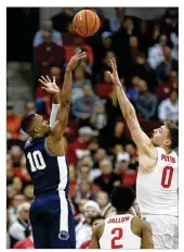  ?? PAUL VERNON / AP ?? Penn State guard Tony Carr shoots over Ohio State guard Musa Jallow and center Micah Potter during the second half Thursday.