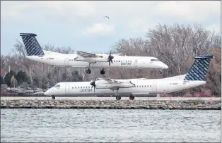  ?? CP PHOTO ?? A Porter Airlines plane lands next to a taxiing plane at Toronto’s Island Airport, in 2015.