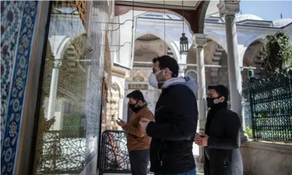  ??  ?? Worshipper­s wearing face masks pray at Istanbul’s Eyüp Sultan mosque. The wearing of masks is compulsory in the country, where internatio­nal flights have been suspended and schools shut. Photograph: Erdem Şahin/EPA