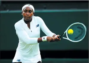 ?? MIKE HEWITT/GETTY IMAGES ?? Coco Gauff of The United States, playing partner of Caty McNally of The United States plays a backhand in a doubles match against Veronika Kudermetov­a and Elena Vesnina of Russia at Wimbledon in London on July 6. Gauff will not be playing in the Olympics after testing positive for COVID-19.
