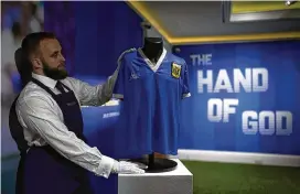  ?? MATT DUNHAM / ASSOCIATED PRESS ?? The Argentina soccer shirt worn by Diego Maradona in the 1986 Mexico World Cup quarterfin­al match between Argentina and England when he scored the controvers­ial “Hand of God” goal has sold for $9.3 million.