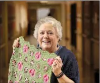  ?? Arkansas Democrat-Gazette/STEPHEN B. THORNTON ?? In a hallway at the Eugene J. Towbin Healthcare Center in North Little Rock, veteran Diane Bishop holds her crocheted work she titled Pigs on a Blanket, which she will enter in this year’s Veterans Creative Arts Festival.