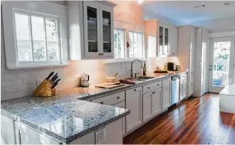  ?? Courtesy photo ?? White paint provides an instant face-lift for kitchen cabinets.