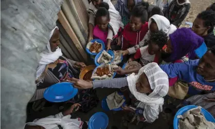  ?? Photograph: Ben Curtis/AP ?? Displaced Tigrayans line up to receive food in Mekele, northern Ethiopia. The federal government has been engaged in an armed conflict against the Tigray People’s Liberation Front for the past year.