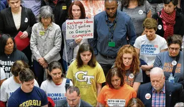  ?? BRANT SANDERLIN / BSANDERLIN@AJC.COM ?? In March 2016, groups opposed to the “campus-carry” bill held a rally inside the Capitol before delivering 30,000 petitions to Gov. Nathan Deal’s office, urging the veto of the bill that now allows those 21 years and older and who have completed a...